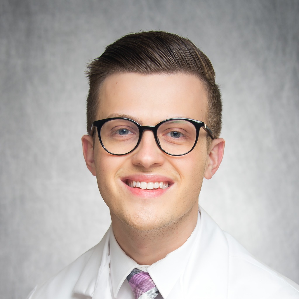 Dr. Poggemiller, a man in glasses wearing a white coat.