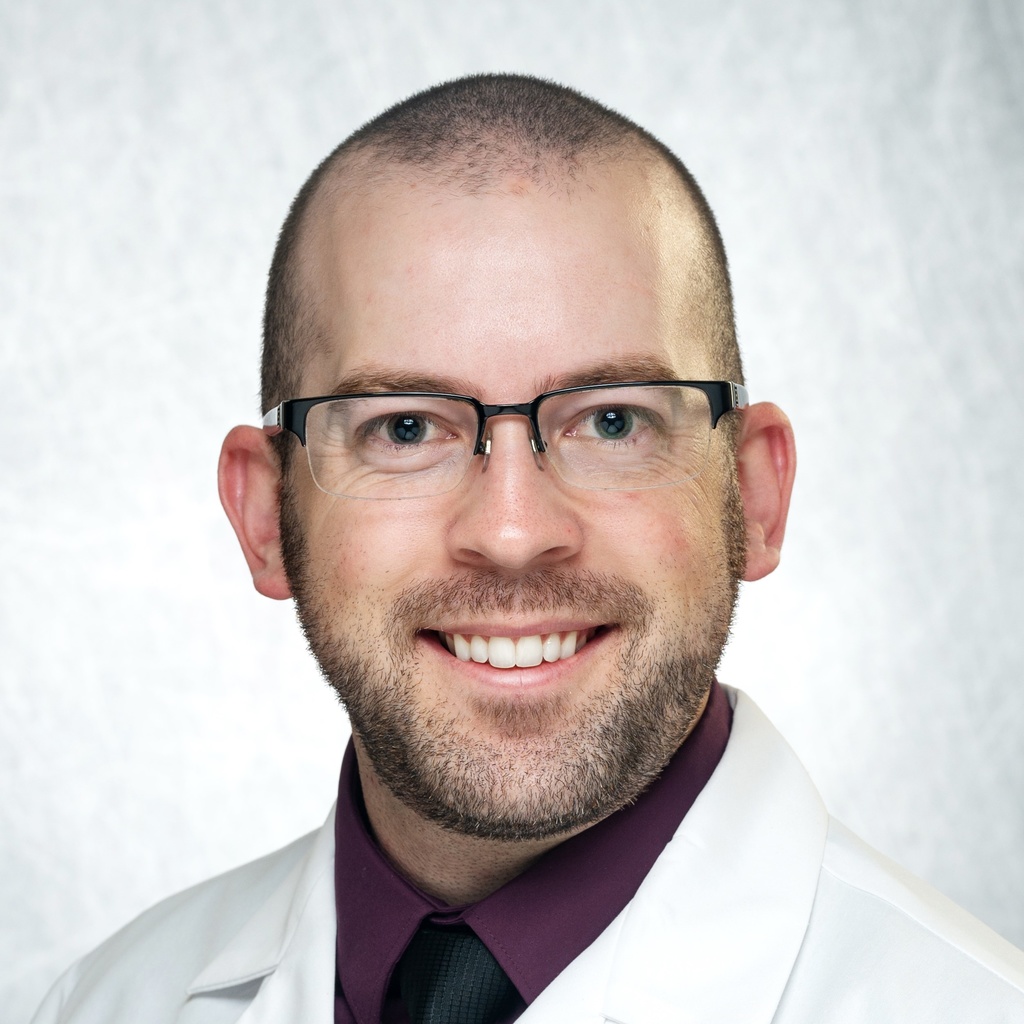 Dr. Dobrzynski, a man with glasses in a white coat.