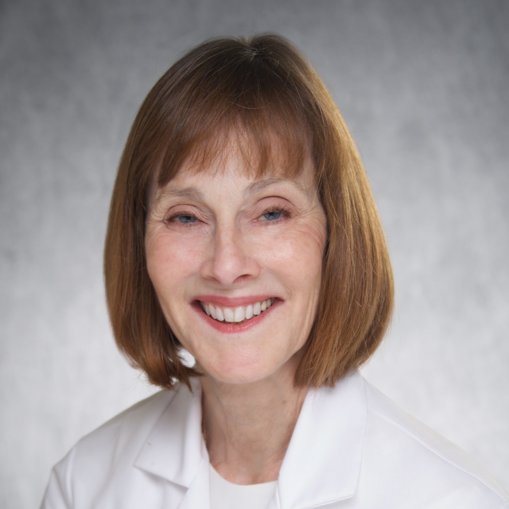 Dr. Fairley, a woman with short red hair wearing a white coat.