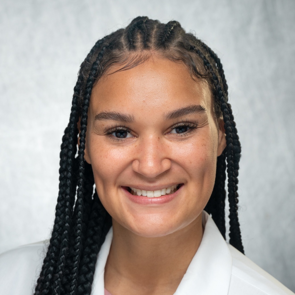 Dr. Newton, a woman with braided hair in a white coat.