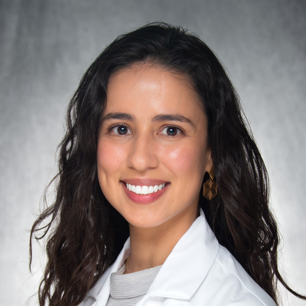Dr. Correa Ferrer, a dark-haired woman in a white coat.