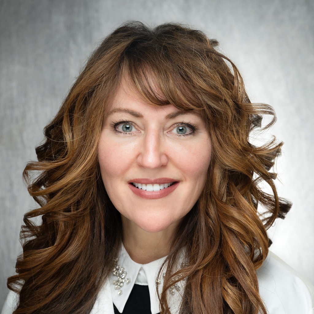 Dr. Van Beek, a woman with curly brown hair wearing a white coat.