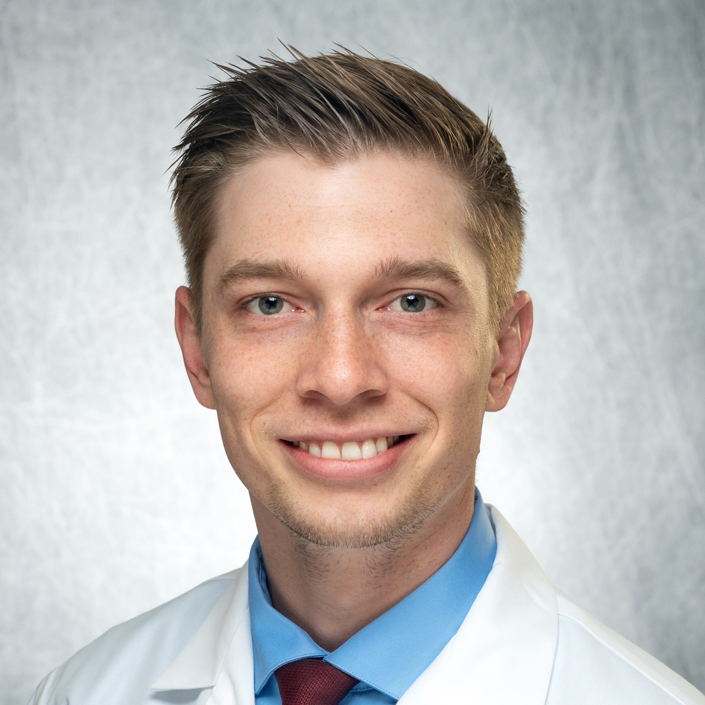 Dr. Skopec, a man in a blue shirt and white coat.