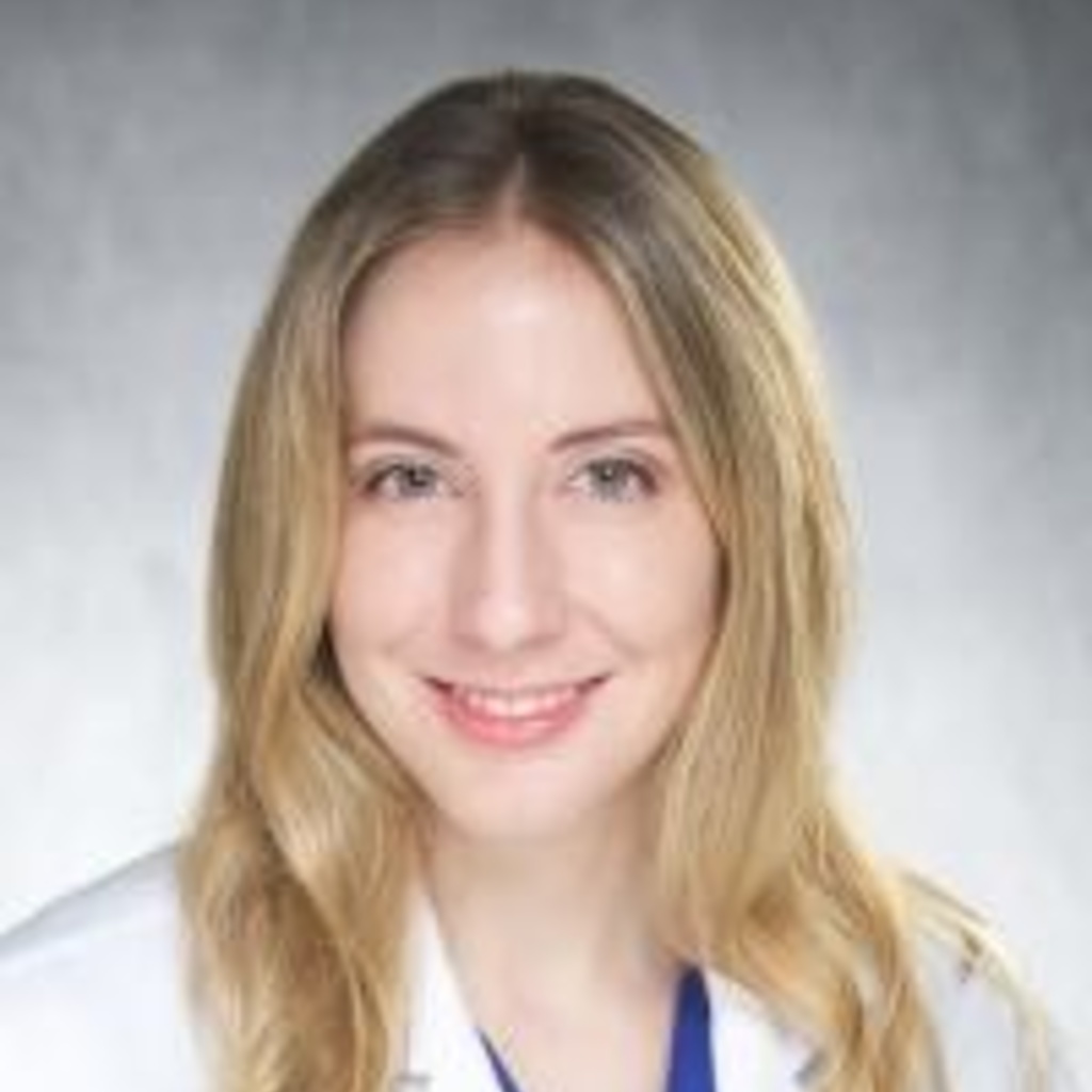 Photo of Katherine Mercy, a blonde woman wearing a white coat