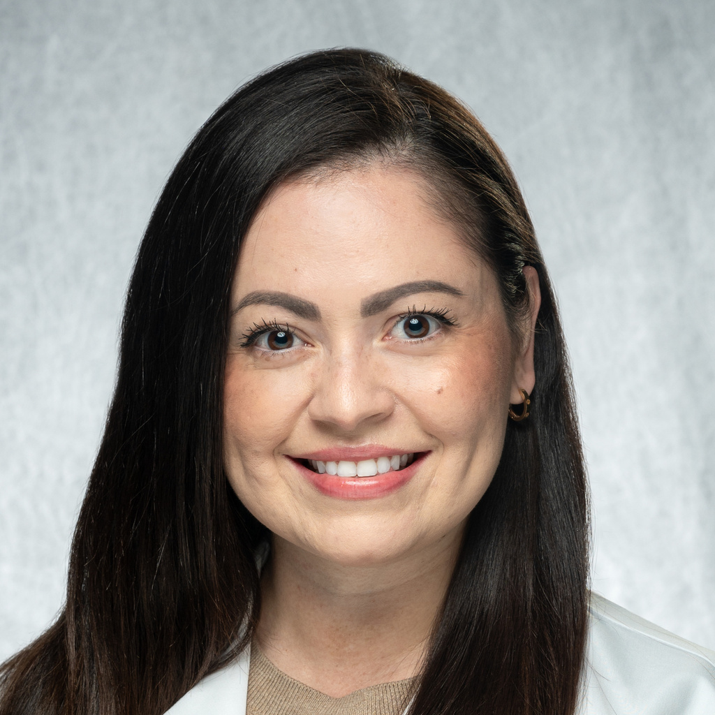 Dr. Arellano Zameza, a dark-haired woman wearing a white coat