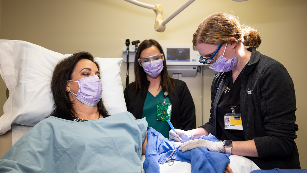 Dermatology procedure with Dr. Melissa Willis, medical assistant Nicole Kranz, and simulated adult patient Jill Imming UIHC Bettendorf - Lincoln Road clinic on Tuesday, Nov. 29, 2022. Patient is an employee actor.