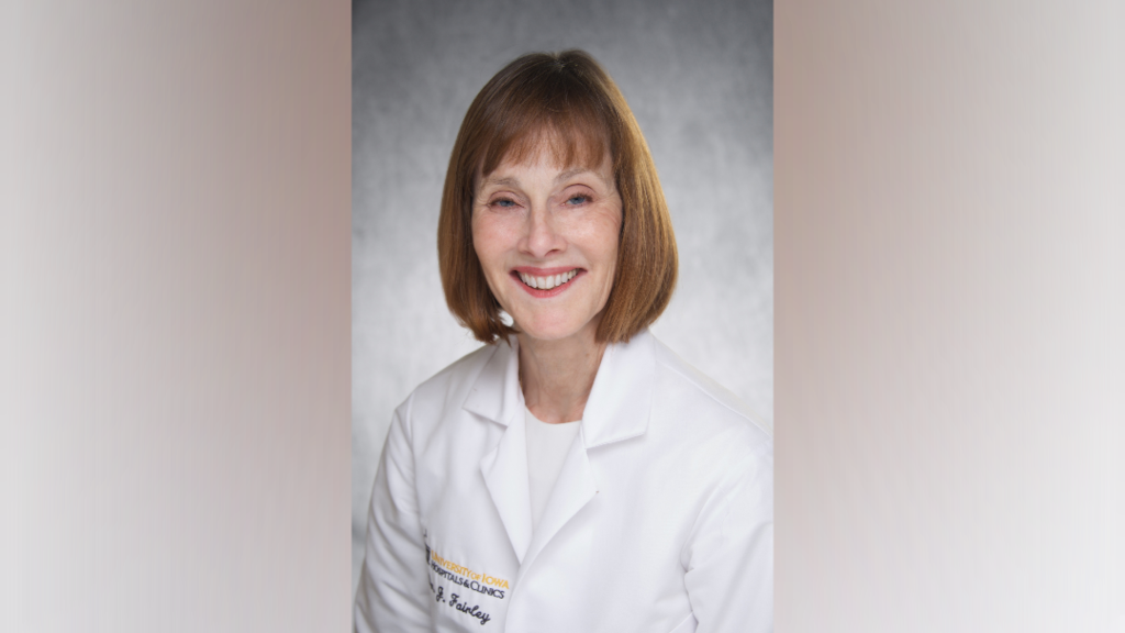 Dr. Fairley, a woman with red hair wearing a white coat.