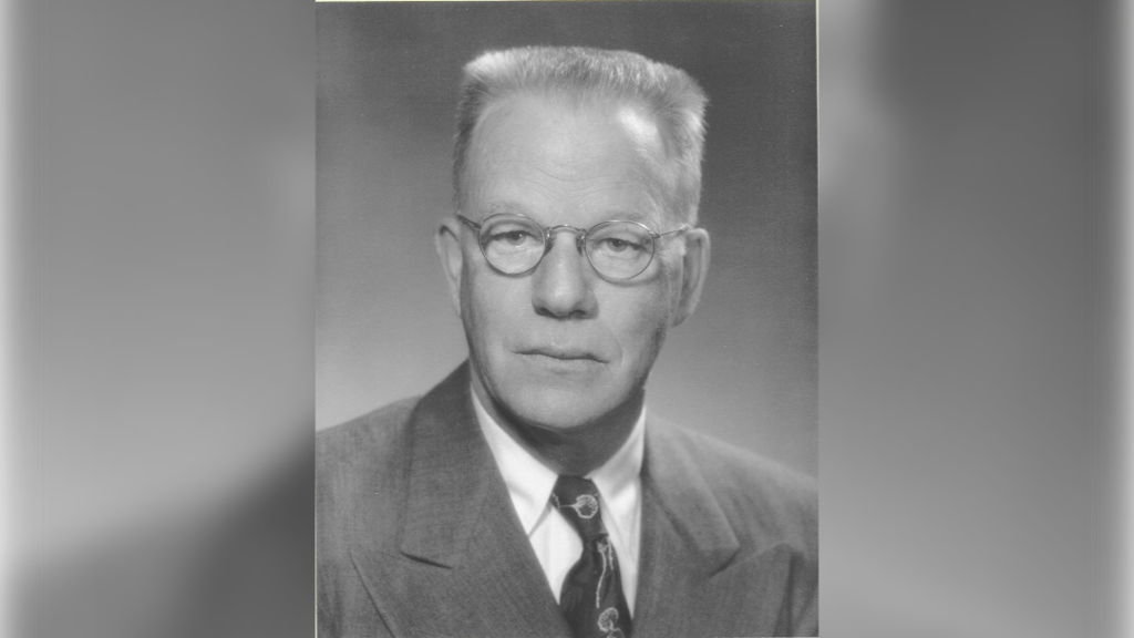 A black and white photo of Dr. Nomland, who wears a suit and eyeglasses.